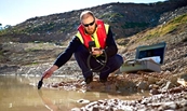 EPA officer sampling dirty water.